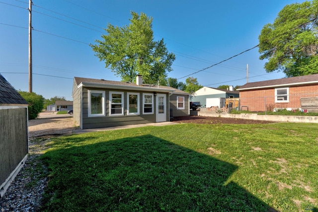 426 E Oakland, Rapid City, SD 57701 - rear view of house featuring a chimney and a yard