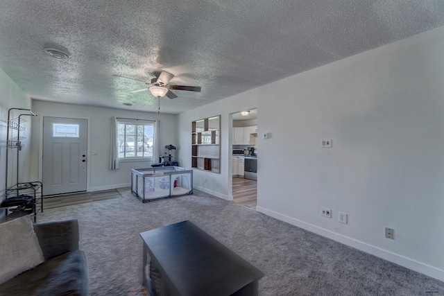 426 E Oakland, Rapid City, SD 57701 - living room featuring carpet flooring, a ceiling fan, a textured ceiling, and baseboards