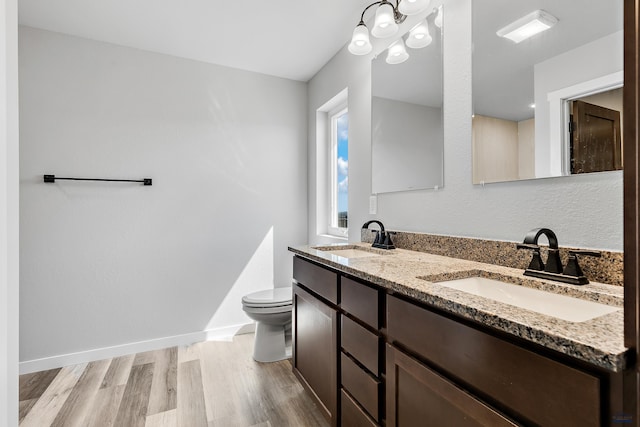 3123 Caymus Dr, Rapid City, SD 57703 - full bathroom featuring toilet, double vanity, wood finished floors, and baseboards