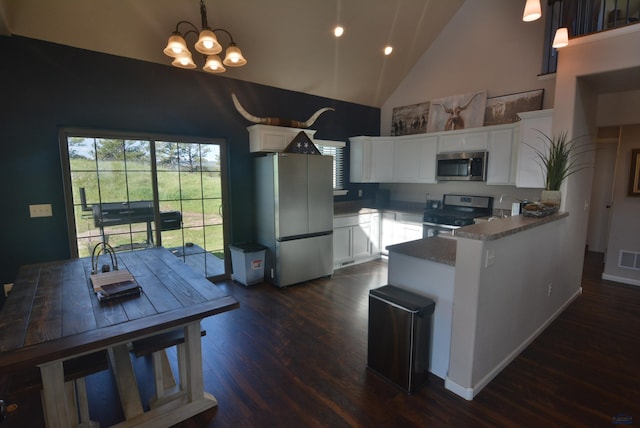 14450 Edgewood Pl, Piedmont, SD 57769 - kitchen featuring stainless steel appliances, high vaulted ceiling, a chandelier, a peninsula, and dark wood-type flooring
