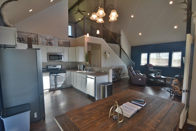 14450 Edgewood Pl, Piedmont, SD 57769 - dining area with high vaulted ceiling, dark wood finished floors, stairway, a chandelier, and recessed lighting