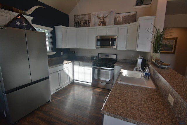 14450 Edgewood Pl, Piedmont, SD 57769 - kitchen featuring appliances with stainless steel finishes, a sink, vaulted ceiling, white cabinets, and dark wood-style floors