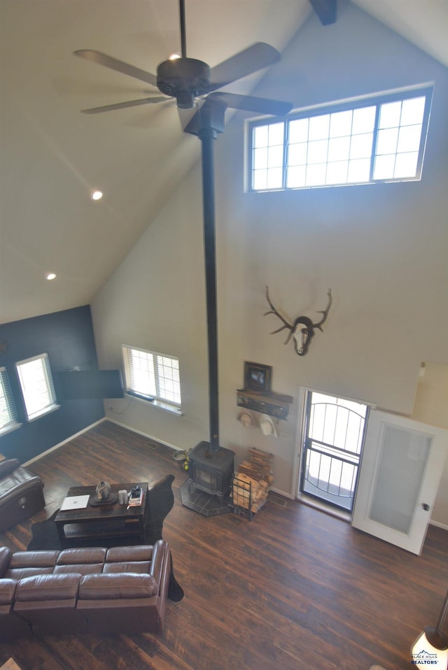 14450 Edgewood Pl, Piedmont, SD 57769 - living area with a wood stove, a ceiling fan, high vaulted ceiling, wood finished floors, and plenty of natural light