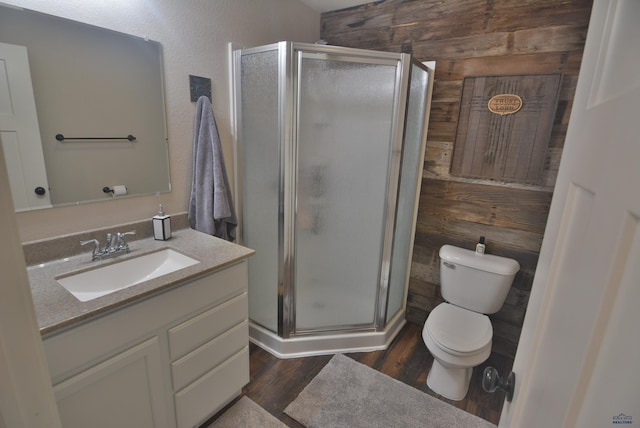 14450 Edgewood Pl, Piedmont, SD 57769 - bathroom with wood walls, wood finished floors, vanity, toilet, and a stall shower