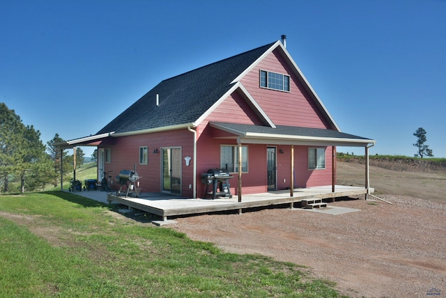 14450 Edgewood Pl, Piedmont, SD 57769 - rear view of house with a shingled roof, a lawn, and a deck