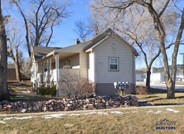 831 Dilger Ave, Rapid City, SD 57701 - view of side of home featuring a chimney