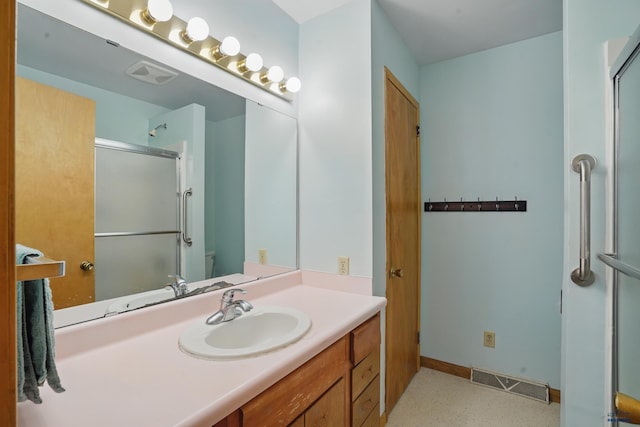 701 Hustead St, Wall, SD 57790 - bathroom featuring vanity, an enclosed shower, toilet, and baseboards