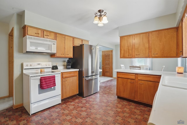 701 Hustead St, Wall, SD 57790 - kitchen with white appliances, light countertops, brick patterned floors, a chandelier, and baseboards