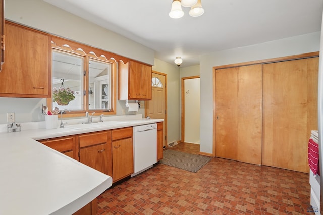 701 Hustead St, Wall, SD 57790 - kitchen featuring white dishwasher, a sink, light countertops, and brick patterned floors