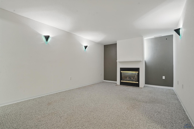 628 Oakland, Rapid City, SD 57701 - unfurnished living room featuring a fireplace with flush hearth, light carpet, and baseboards
