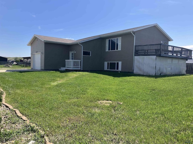 6323 Felicia St, Rapid City, SD 57703 - rear view of house with a garage, a lawn, and a deck