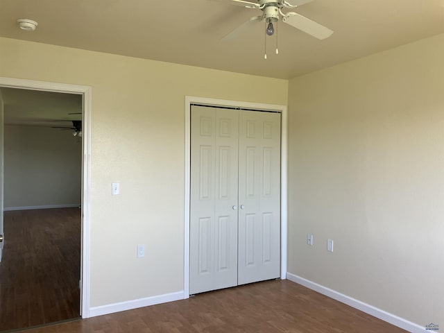 6323 Felicia St, Rapid City, SD 57703 - unfurnished bedroom with dark wood-style floors, baseboards, a closet, and ceiling fan