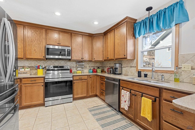 3513 Chapel Valley Rd, Rapid City, SD 57702 - kitchen with stainless steel appliances, a sink, tasteful backsplash, brown cabinetry, and recessed lighting
