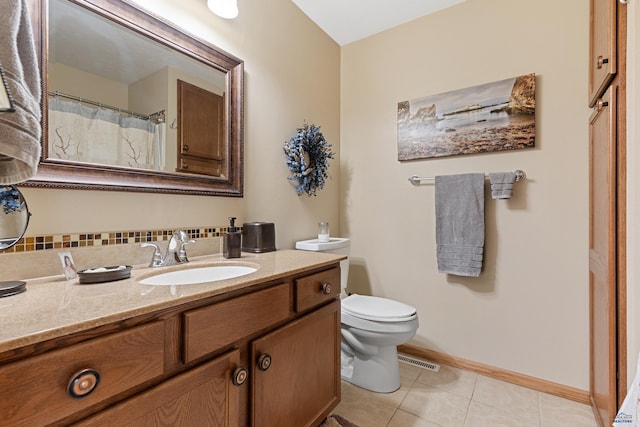 3513 Chapel Valley Rd, Rapid City, SD 57702 - full bath with vanity, toilet, tile patterned flooring, and baseboards