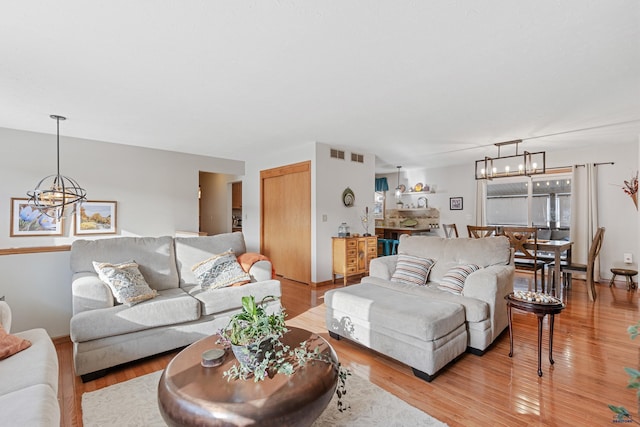 3513 Chapel Valley Rd, Rapid City, SD 57702 - living area with a chandelier and light wood-style floors