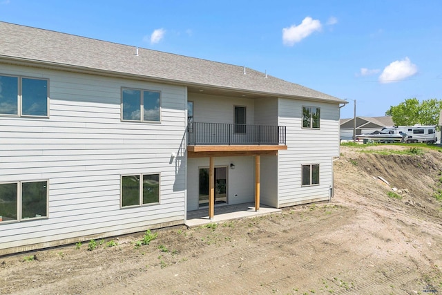 3053 Hoefer Ave, Rapid City, SD 57701 - back of property with a balcony, a patio area, and roof with shingles