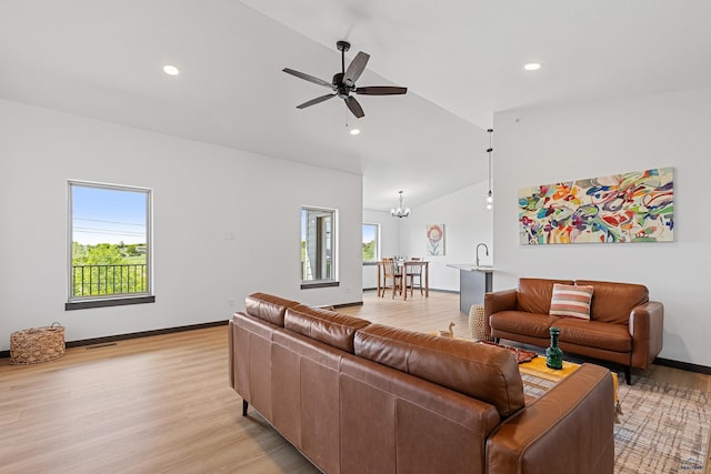 3053 Hoefer Ave, Rapid City, SD 57701 - living room featuring vaulted ceiling, light wood-style floors, a ceiling fan, a chandelier, and recessed lighting