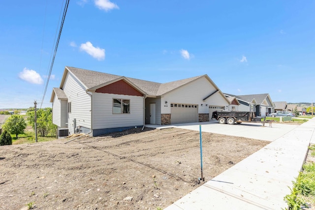3051 Hoefer Ave, Rapid City, SD 57701 - view of front of house featuring an attached garage, central AC unit, and concrete driveway