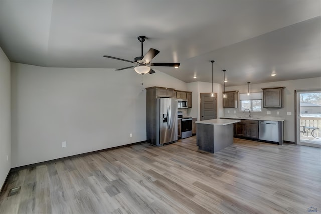 3553 Blackpowder Rd, Rapid City, SD 57703 - kitchen with appliances with stainless steel finishes, light countertops, light wood-style flooring, and lofted ceiling