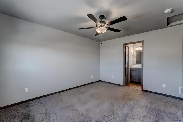 3553 Blackpowder Rd, Rapid City, SD 57703 - unfurnished bedroom with light colored carpet, baseboards, ensuite bath, and ceiling fan