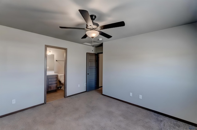 3553 Blackpowder Rd, Rapid City, SD 57703 - unfurnished bedroom with baseboards, light carpet, ensuite bathroom, and a ceiling fan