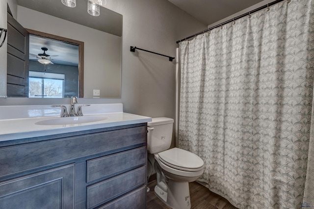 3553 Blackpowder Rd, Rapid City, SD 57703 - bathroom featuring wood finished floors, toilet, vanity, a shower with shower curtain, and a ceiling fan