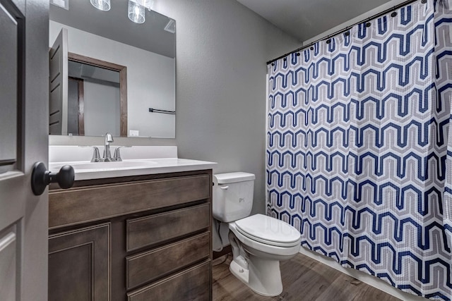 3553 Blackpowder Rd, Rapid City, SD 57703 - bathroom with toilet, vanity, wood finished floors, and a shower with shower curtain