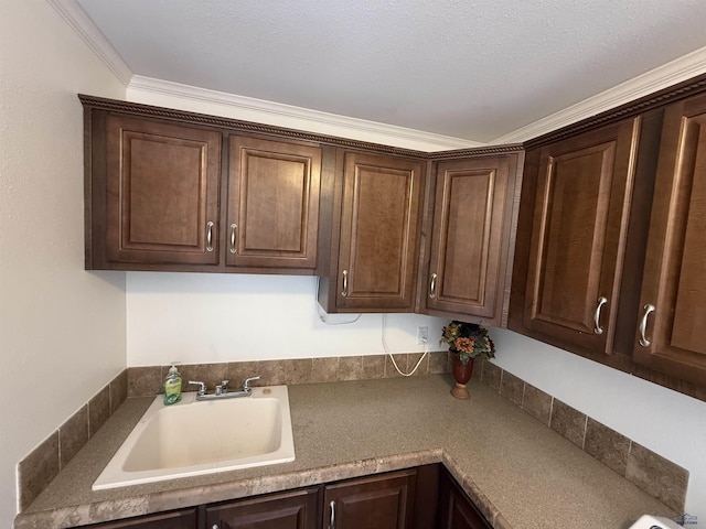 1222 Foothill Dr, Spearfish, SD 57783 - kitchen with a sink, dark brown cabinets, ornamental molding, and dark countertops