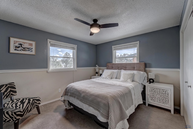 239 Deer Path, Lead, SD 57754 - carpeted bedroom with a ceiling fan, a textured ceiling, and baseboards