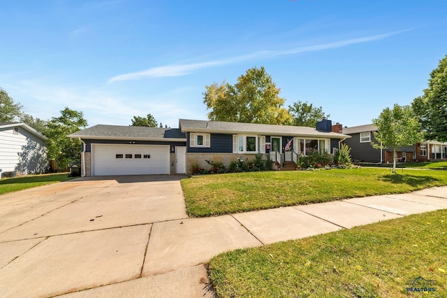 3112 Flint Dr, Rapid City, SD 57702 - view of front of home with an attached garage, a front lawn, concrete driveway, and brick siding