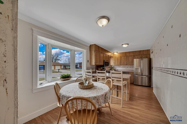 3112 Flint Dr, Rapid City, SD 57702 - dining room with light wood-style flooring and baseboards