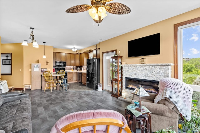 4035 Fairway Hills Dr, Rapid City, SD 57702 - living area featuring baseboards, a ceiling fan, and a stone fireplace