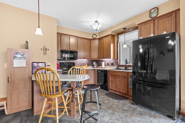 4035 Fairway Hills Dr, Rapid City, SD 57702 - kitchen with black appliances, brown cabinets, tasteful backsplash, and decorative light fixtures