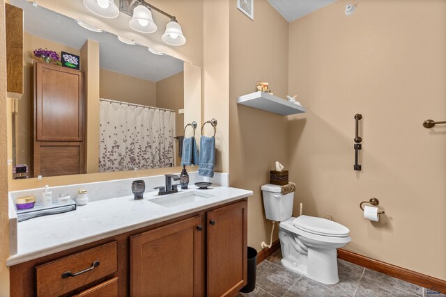4035 Fairway Hills Dr, Rapid City, SD 57702 - bathroom featuring baseboards, toilet, vanity, and tile patterned floors