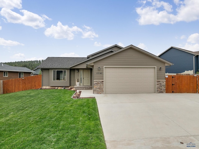 10145 Laramie Ln, Summerset, SD 57718 - single story home featuring an attached garage, concrete driveway, stone siding, and roof with shingles
