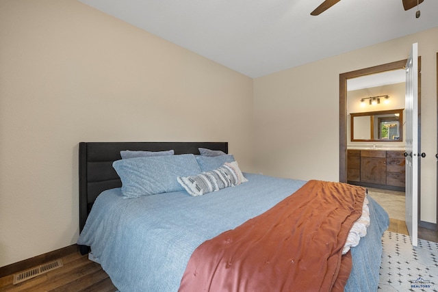 10145 Laramie Ln, Summerset, SD 57718 - bedroom featuring wood finished floors, ensuite bath, baseboards, and ceiling fan