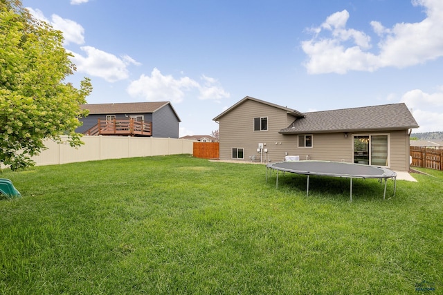 10145 Laramie Ln, Summerset, SD 57718 - back of property featuring a trampoline and a shingled roof