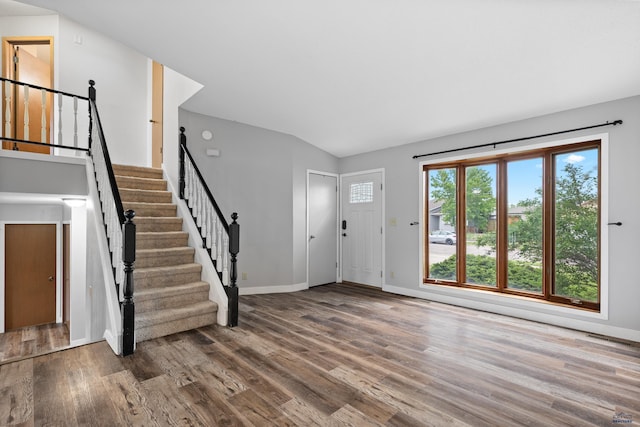 1705 Copperdale Dr, Rapid City, SD 57703 - entrance foyer with wood finished floors, stairs, baseboards, and vaulted ceiling