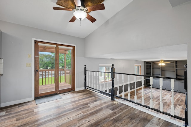 1705 Copperdale Dr, Rapid City, SD 57703 - spare room with wood finished floors, baseboards, ceiling fan, and high vaulted ceiling