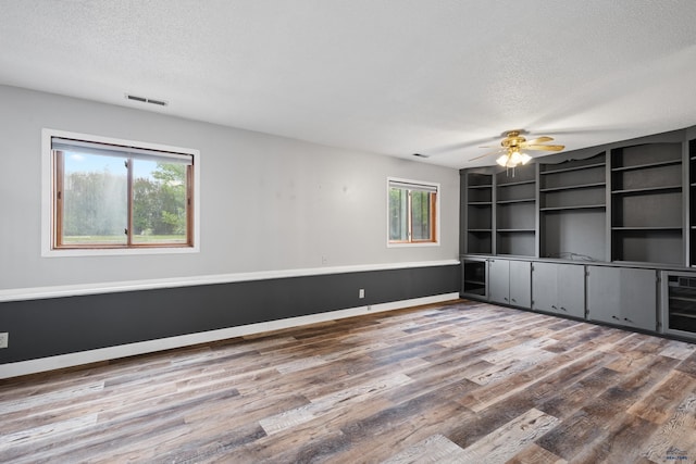 1705 Copperdale Dr, Rapid City, SD 57703 - unfurnished room featuring a textured ceiling, wood finished floors, a ceiling fan, and baseboards