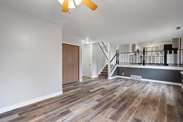 1705 Copperdale Dr, Rapid City, SD 57703 - unfurnished living room with wood finished floors, baseboards, a ceiling fan, and stairway
