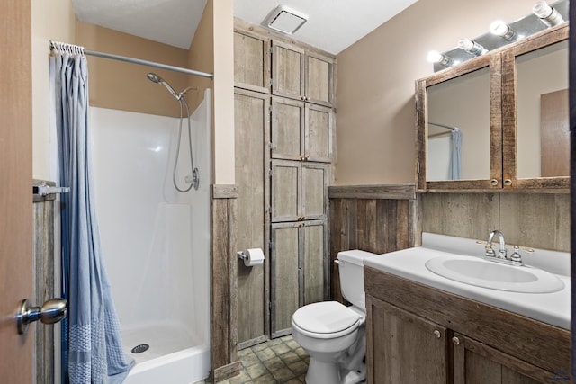 1705 Copperdale Dr, Rapid City, SD 57703 - full bathroom featuring toilet, a stall shower, vanity, and wainscoting