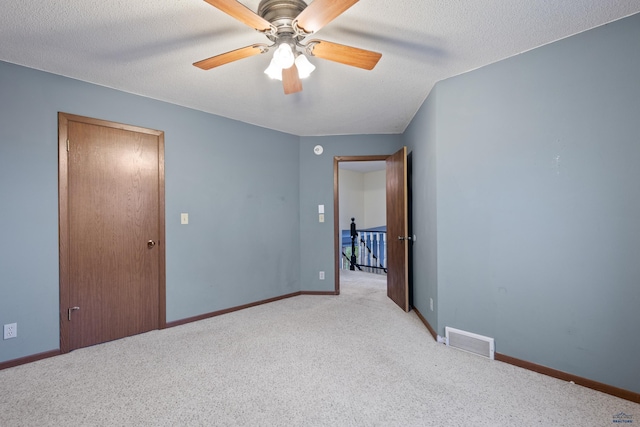 1705 Copperdale Dr, Rapid City, SD 57703 - empty room featuring light carpet, ceiling fan, baseboards, and a textured ceiling
