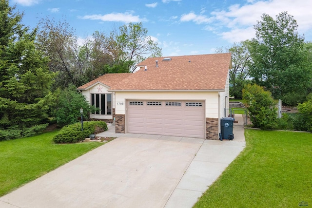 1705 Copperdale Dr, Rapid City, SD 57703 - view of front of home with brick siding, driveway, a front lawn, and a garage