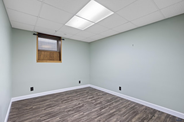 1705 Copperdale Dr, Rapid City, SD 57703 - spare room featuring dark wood-type flooring, a drop ceiling, and baseboards