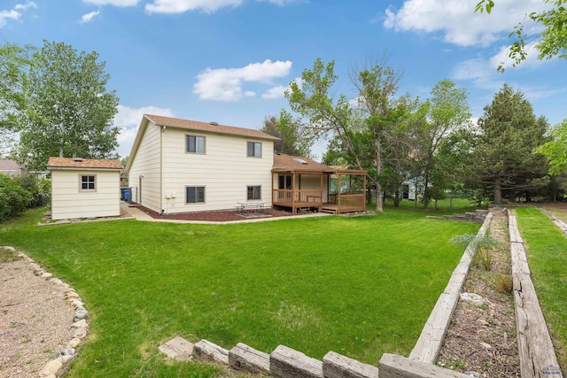 1705 Copperdale Dr, Rapid City, SD 57703 - rear view of property with a deck, a lawn, and an outbuilding