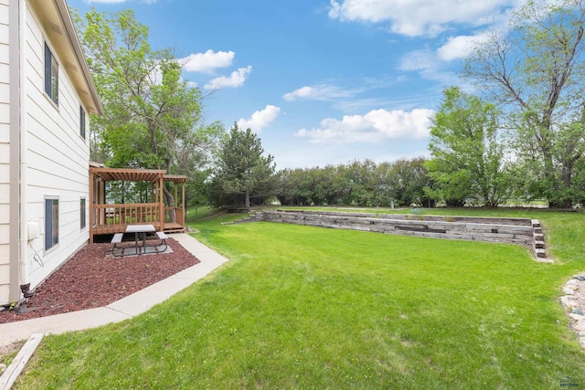 1705 Copperdale Dr, Rapid City, SD 57703 - view of green lawn featuring a deck, a pergola, and view of scattered trees