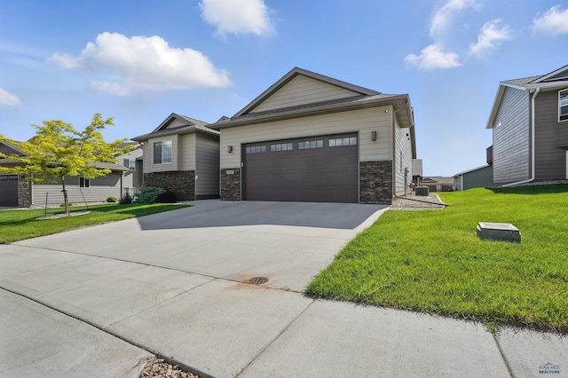 4528 Lahinch St, Rapid City, SD 57702 - view of front of property with driveway, a front lawn, a garage, and central air condition unit
