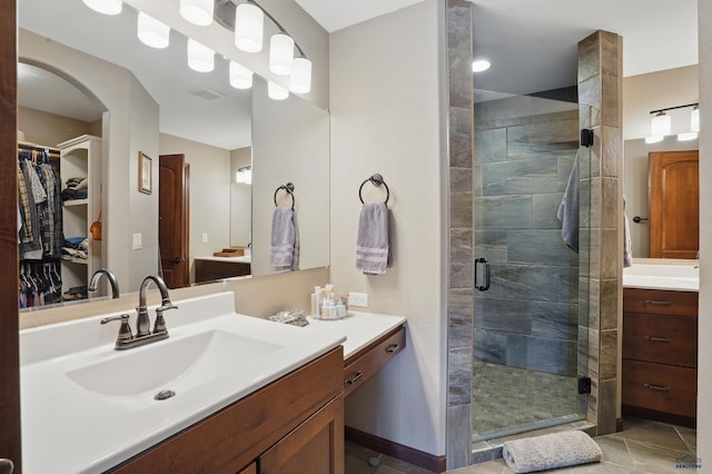 4528 Lahinch St, Rapid City, SD 57702 - bathroom with vanity, a shower stall, a spacious closet, and tile patterned floors