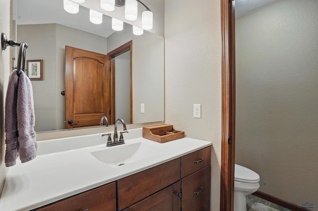 4528 Lahinch St, Rapid City, SD 57702 - bathroom featuring vanity, toilet, and a textured wall
